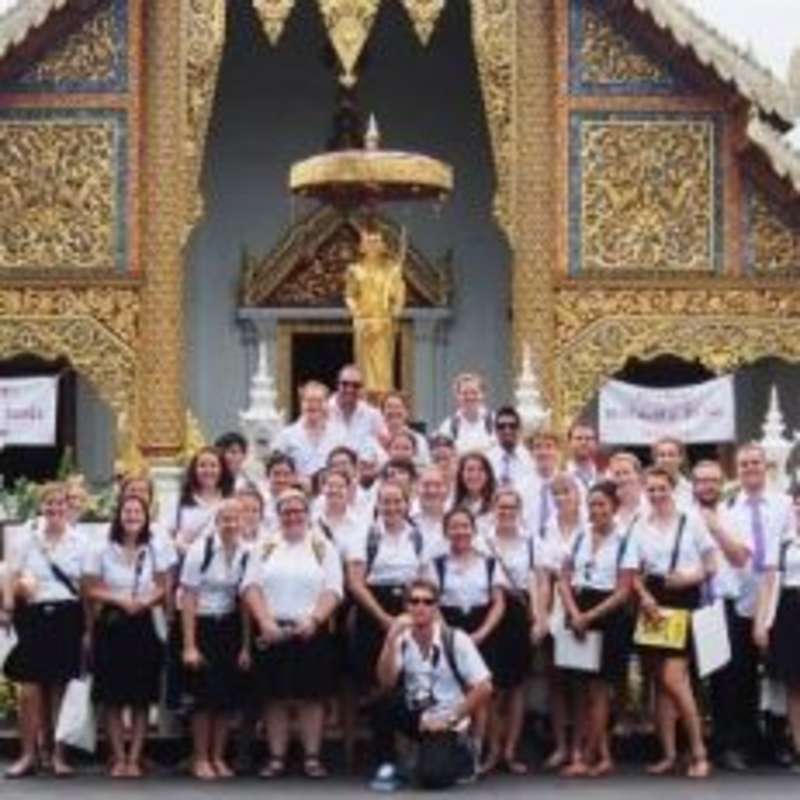 International students posing in front of a church