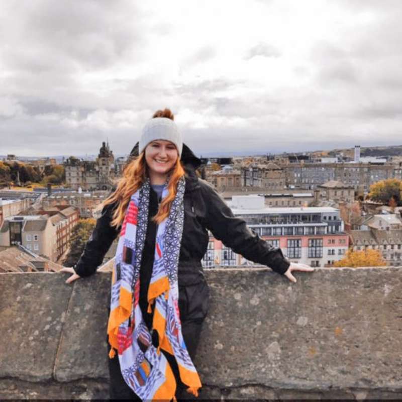 Student posed in front of the city skyline