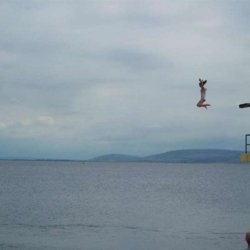 Student jumping into the bay