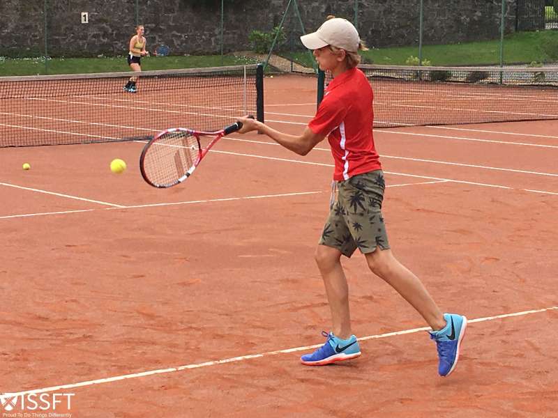 student learning tennis