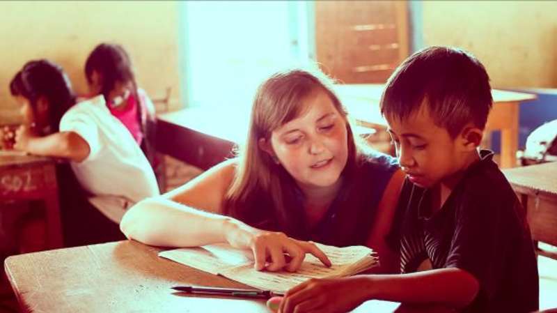 volunteer teaching a child