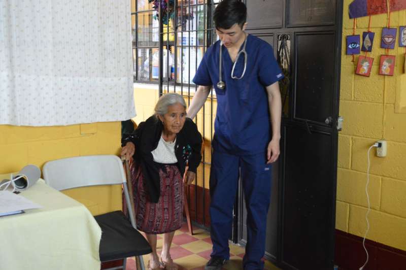 IVHQ Male Volunteer Assisting a Senior Citizen with a Checkup