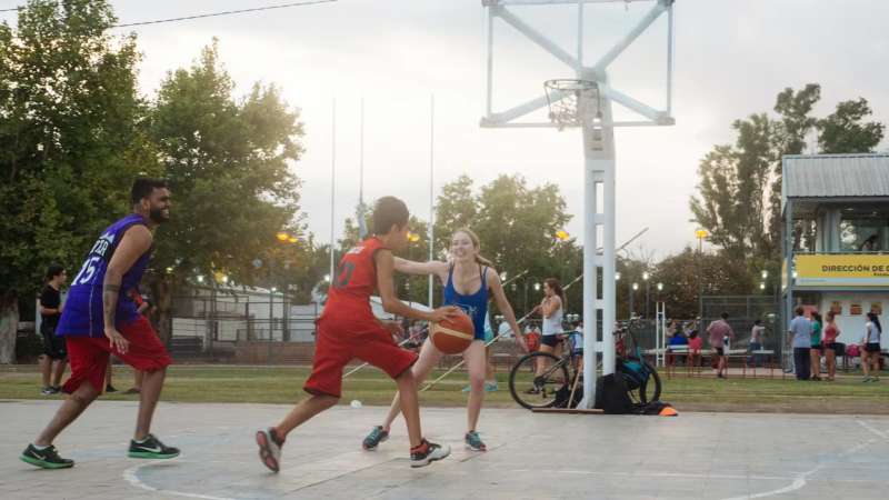 IVHQ Volunteer playing basketball with two teenagers in Argentina