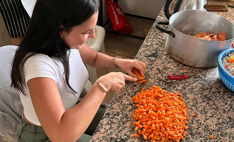 IVHQ Volunteer prepping food to serve to the local community