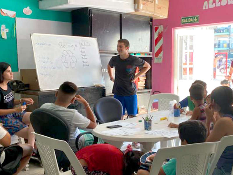 IVHQ Volunteer teaching a class of children about recycling 
