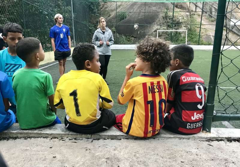IVHQ Volunteers playing football with students in Brazil