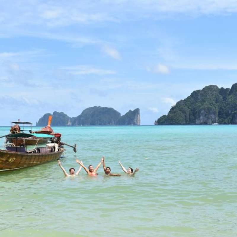 teens swimming at a Thailand beach
