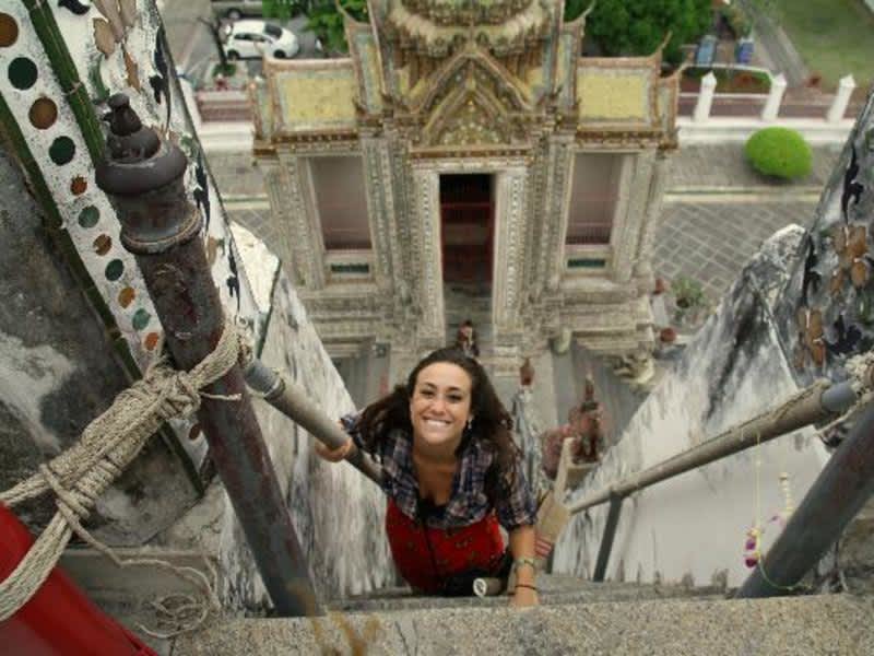 Lady Climbing a high ladder