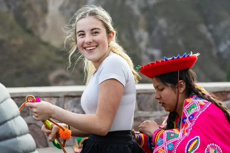 Local helps student put on traditional garb