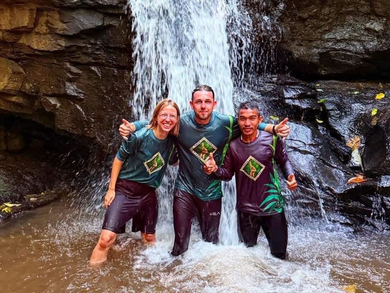 Local staff and volunteers at a waterfall near Huay Pakoot