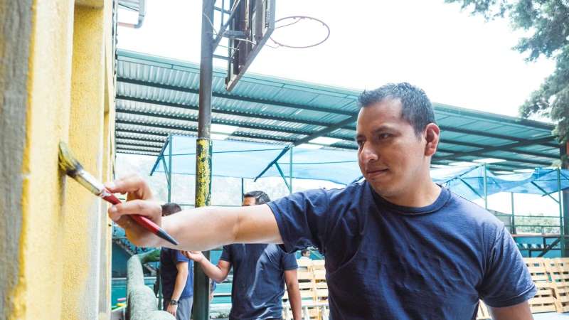 Male Volunteer Painting a School in Guatemala