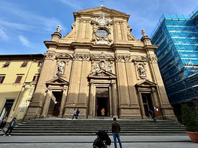 Man looking at old building next to modern building in Florence