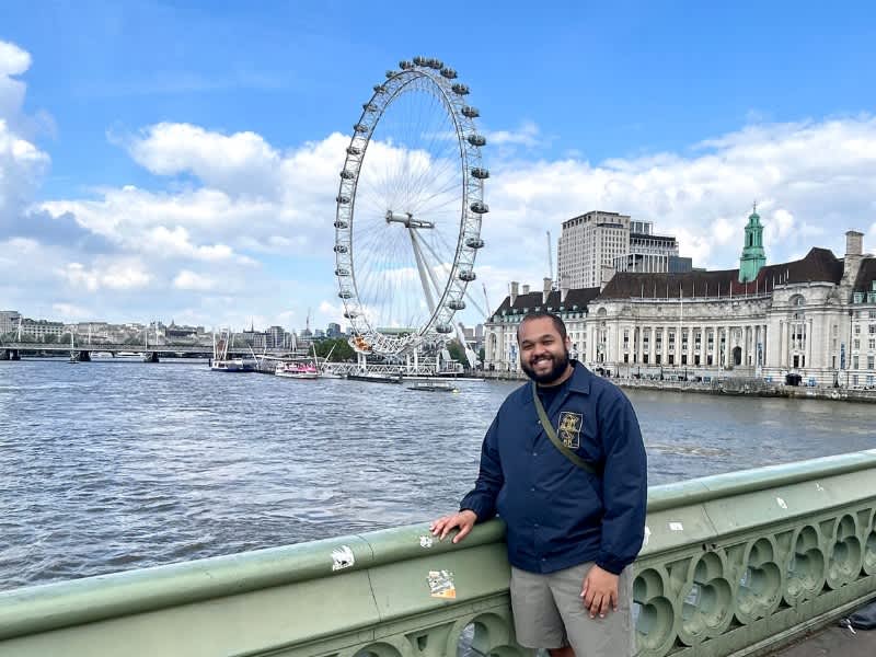 Man standing in front of the London Eye
