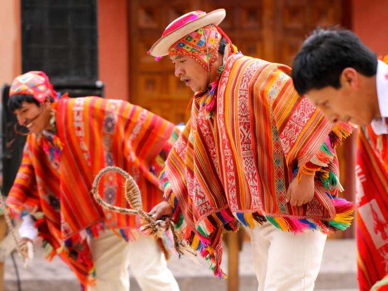 Men in brightly colored traditional clothing in Peri
