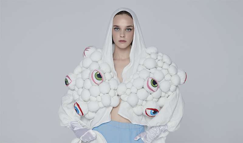Model wearing white decorated hooded jacket