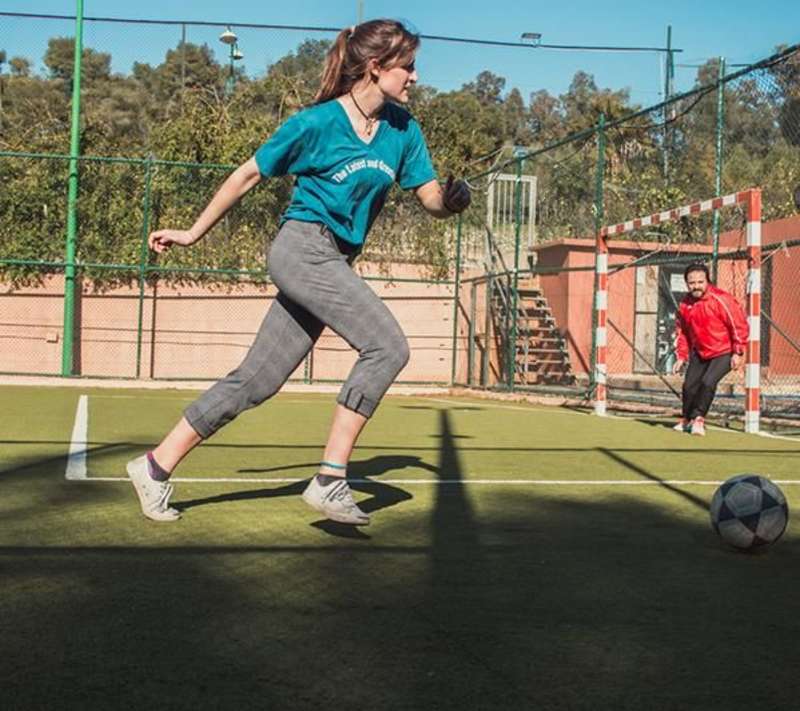 Student playing soccer in rabat