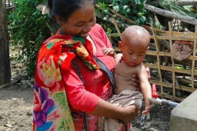 Mother carrying a baby