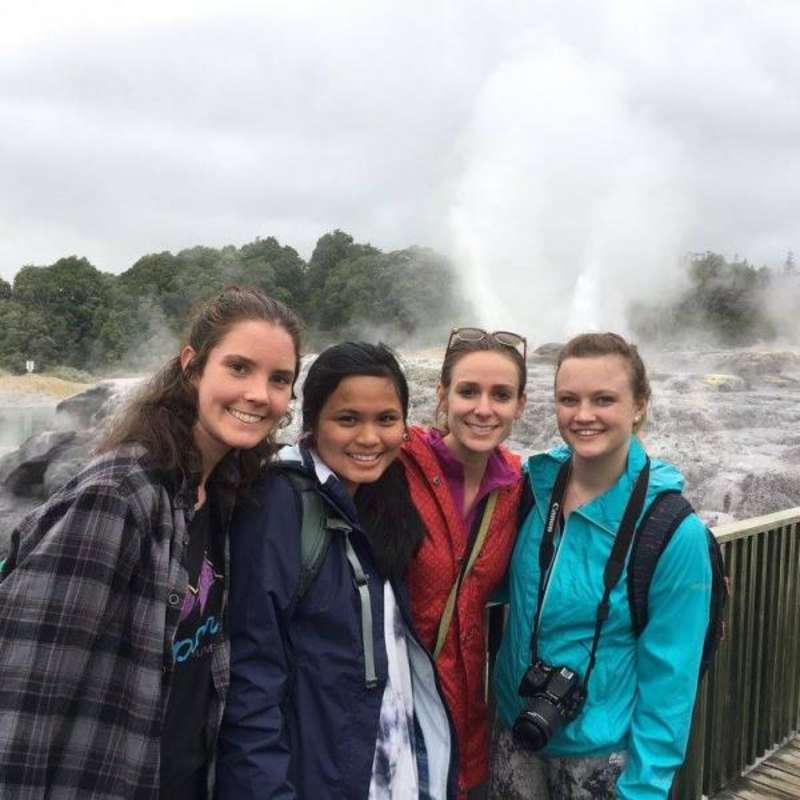 group of students in front of natural waterfall and springs