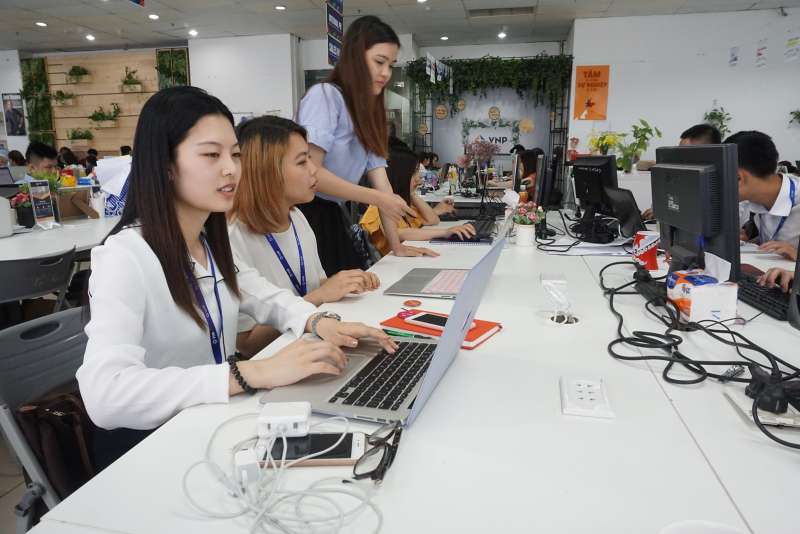 Office workers at computer desks.