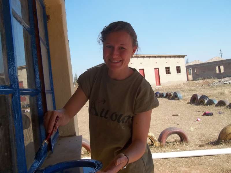 Volunteer painting windows