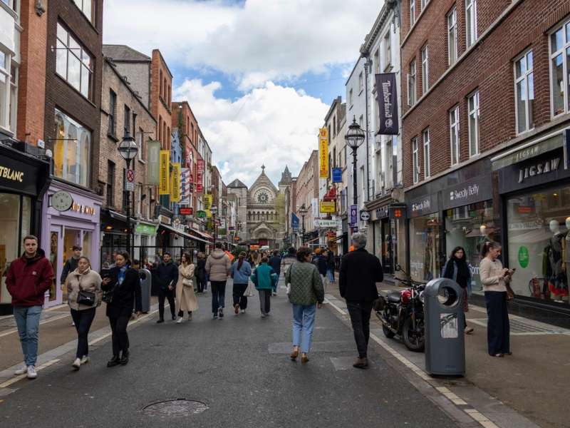 Pedestrians walking a main shopping street in Dublin