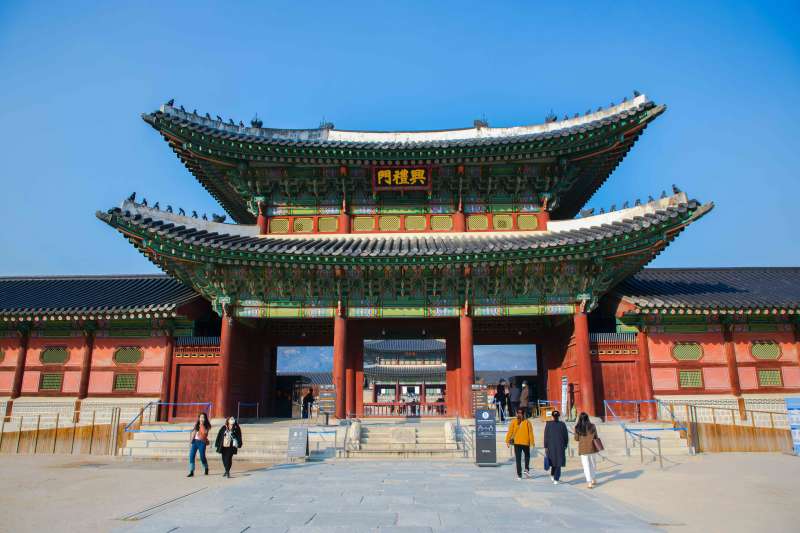 People walk into a Korean temple