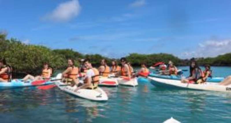 Person kayaking in turquoise waters of lagoon