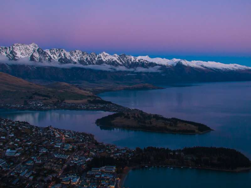 Queenstown skyline and mountains in New Zealand at sunset