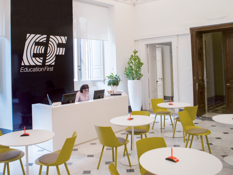 Reception area at EF Rome language school with modern seating, bright decor, and a welcoming front desk for students.
