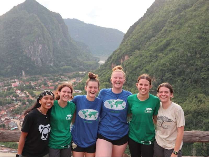 Scenic photo of volunteers in rural Laos posing