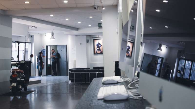 School reception entrance area. Two people chatting at the doorway