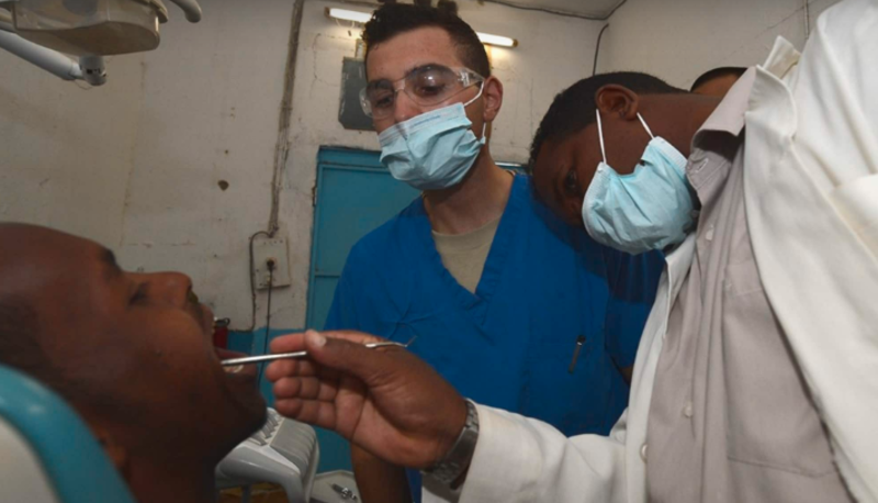 The dentist checking his patient's teeth.