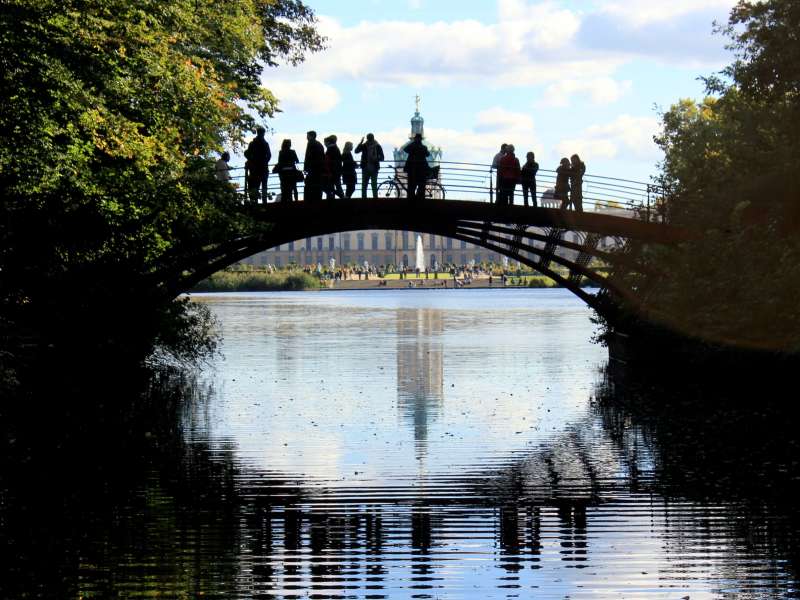 Silhouettes of people on a bridge