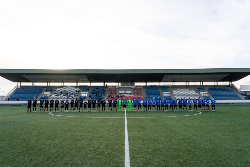 soccer players lined up in a straight line on the field