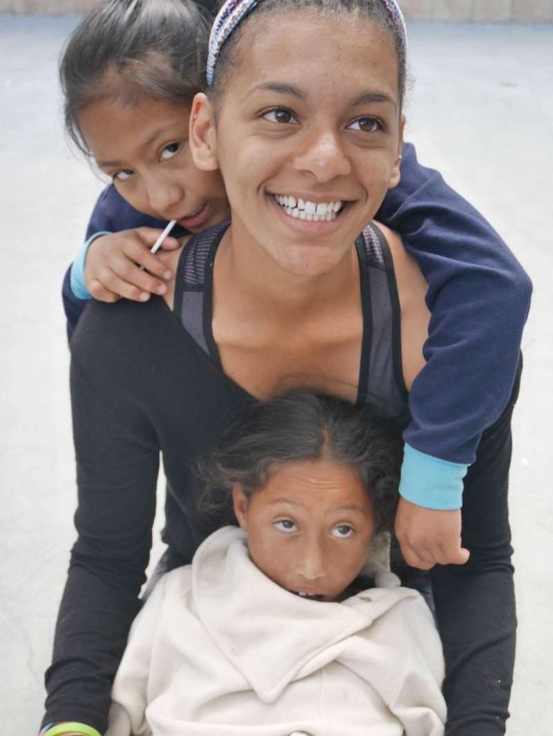 Social work intern engaging with children in Ecuador as part of an international internship