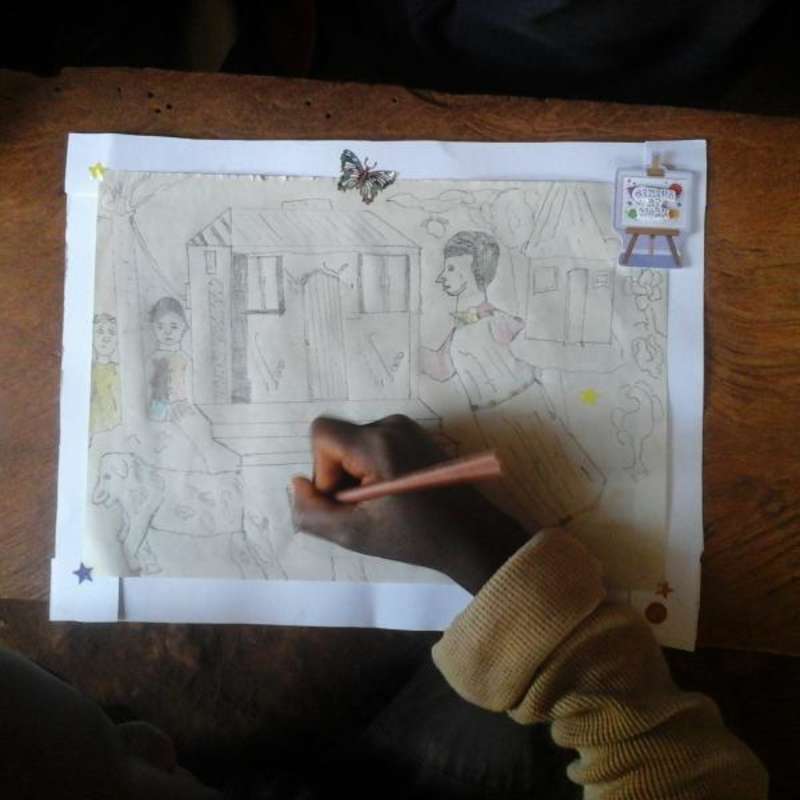 doing crafts with the kids at a school in Uganda