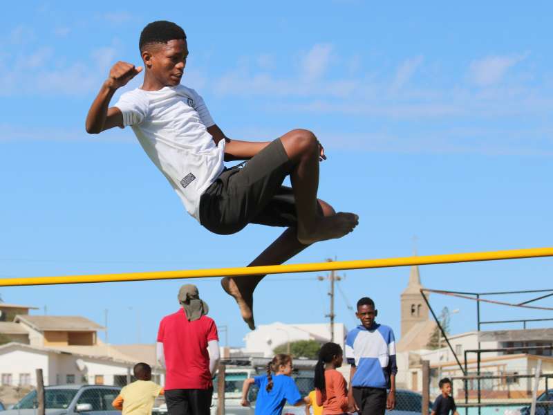 Student competing in high jump at LBS sports day, Lüderitz