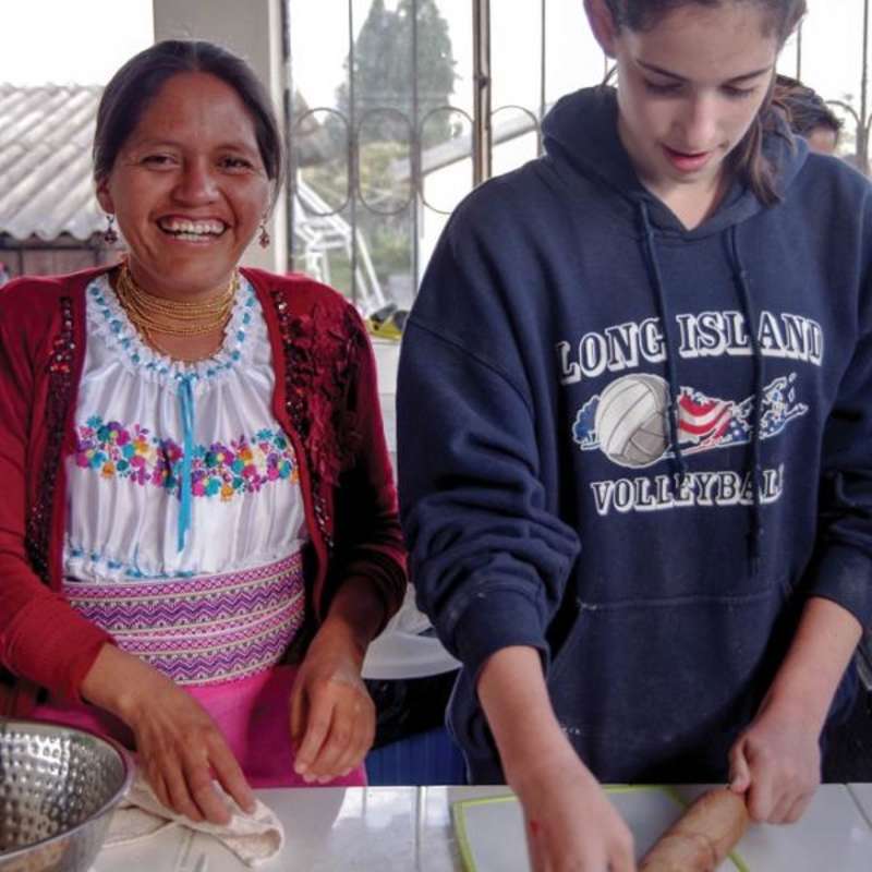 student cooking with woman in ecuador