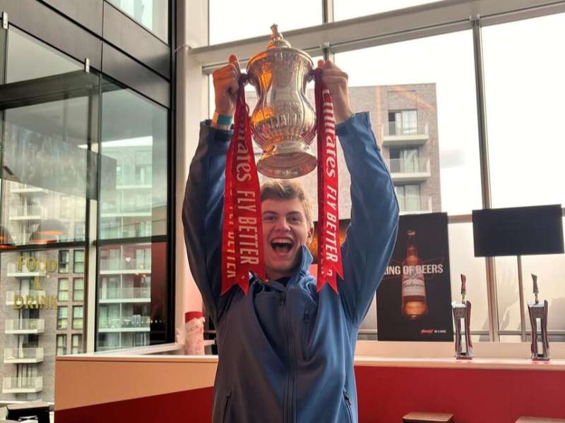 Student holding up Emirates Cup