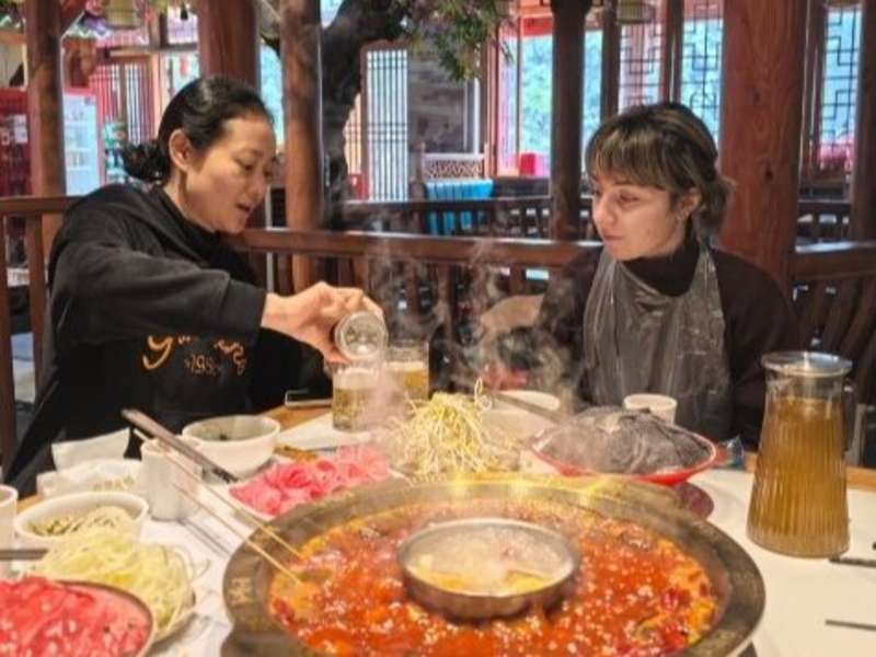 Student in a restaurant with her teacher in Chongqing