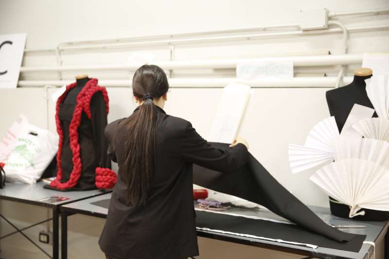 Student in Fashion Design class manoeuvring fabric