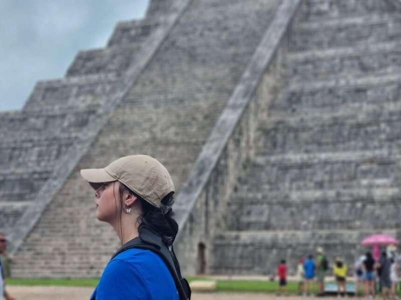 Student in Yucatan with pyramid behind her