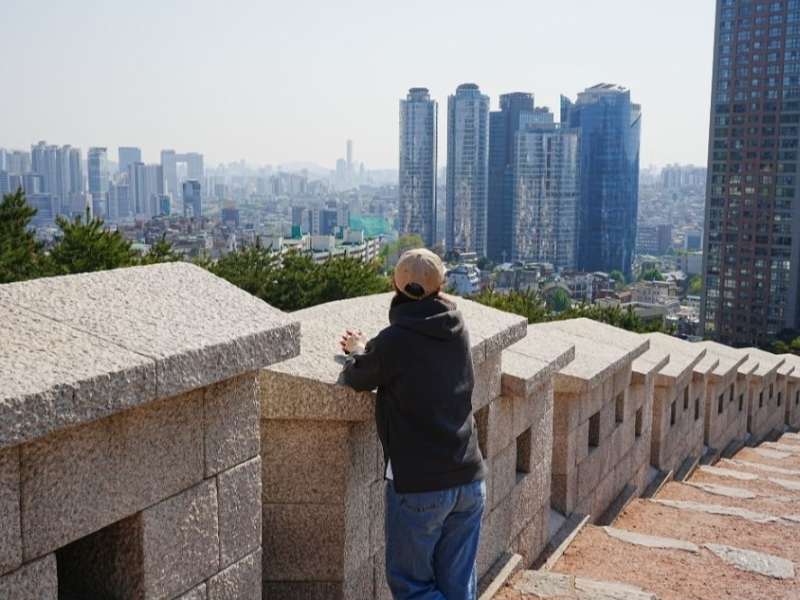 Student looking out at city-scape in South Korea