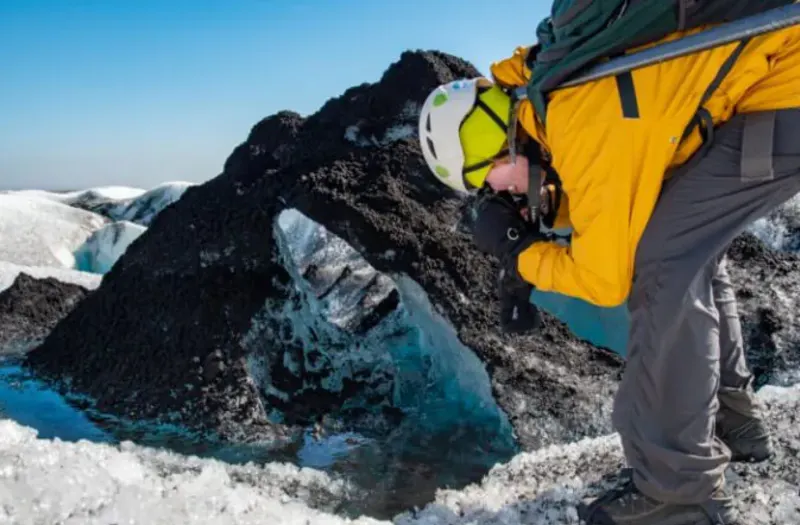 Student photographs mountain ice