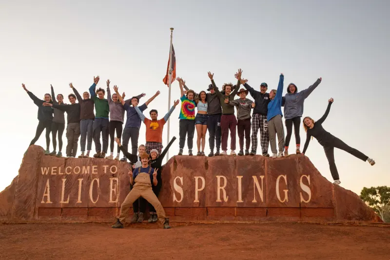 Student pose in front of Alice Springs sign