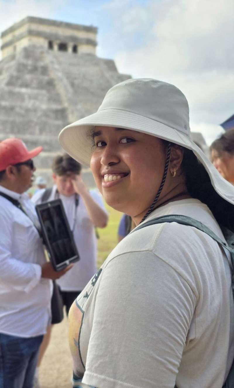 Student posing in front of temple in Chichen itza