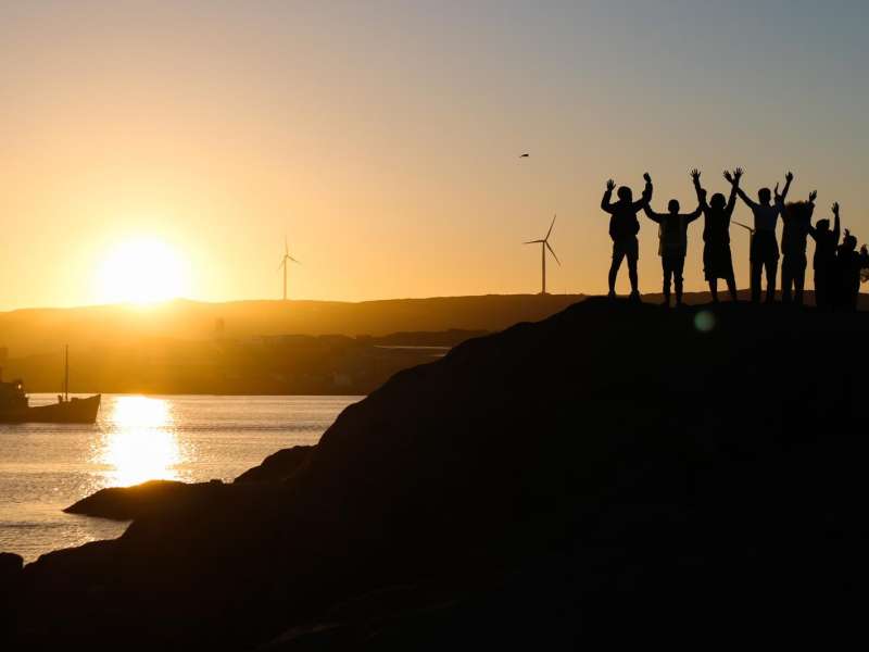 Student silhouettes at sunset over Lüderitz coastline