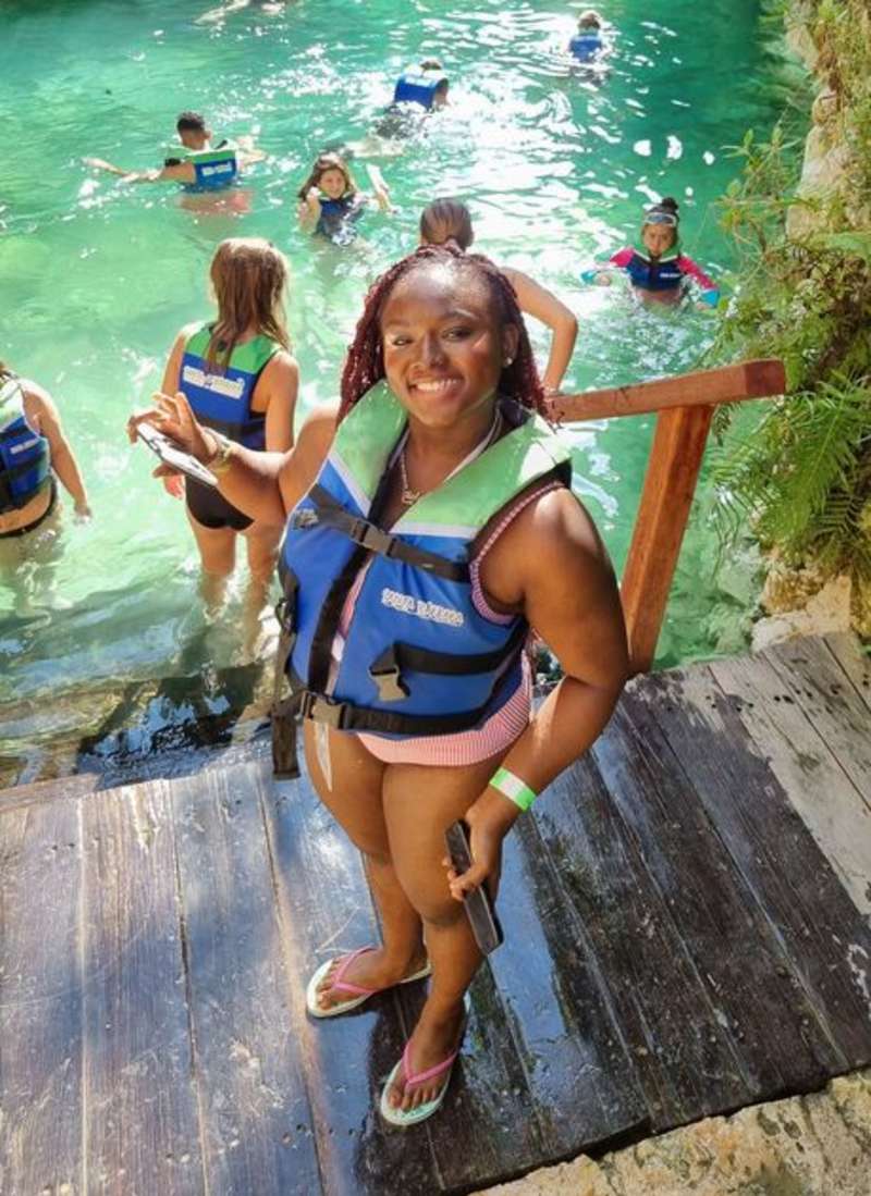 Student smiling above water in Mexico