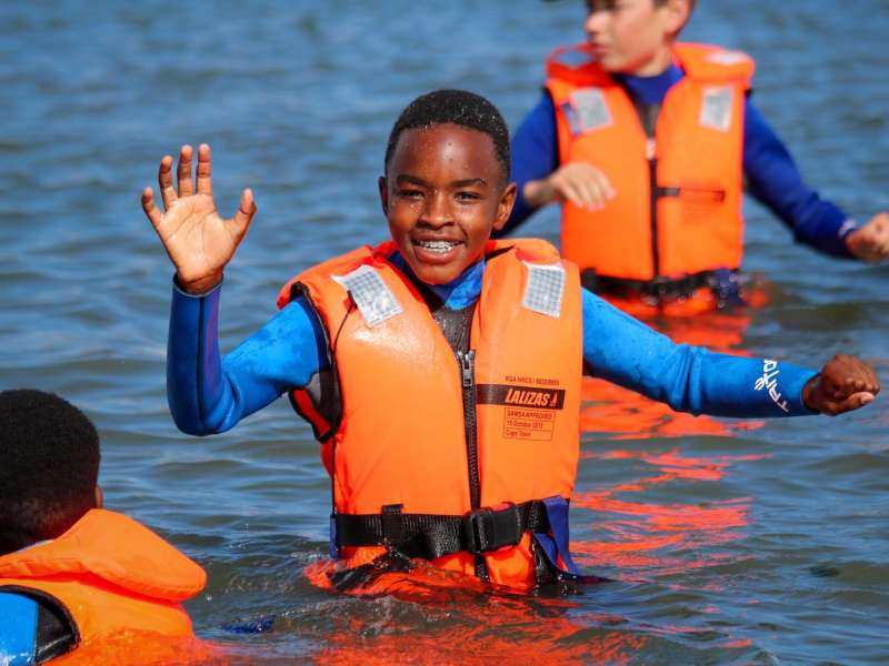 Student smiling in the ocean