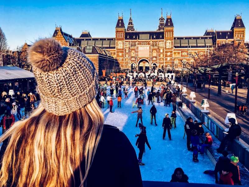Student standing in front of ice skating rink